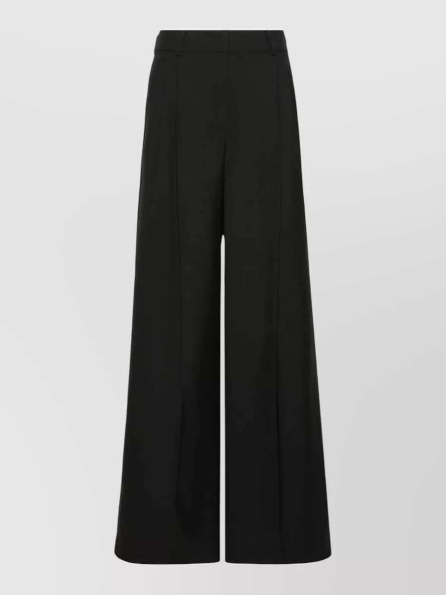 Weekend Max Mara Virgin wool high-rise wide-leg pleated trousers — The high-rise black wide-leg trouser gives the simple black tee a modern, elongated silhouette that still reads quietly polished for work-to-weekend.