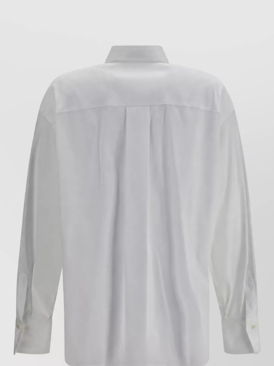 Brunello Cucinelli Cotton blend regular-fit shirt — The cream relaxed shirt keeps the palette light and tonal with the taupe trouser, and its fluid cut tucks neatly to balance the high-waisted wide leg in a quietly luxurious way.