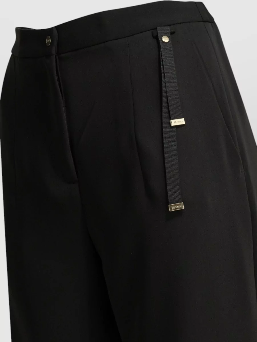 Herno Straight-leg trousers — The soft white straight-leg trouser gives a crisp, tailored contrast to the black A-line top, keeps the palette quietly luxurious, and suits warm-weather city dressing at the same formality level.