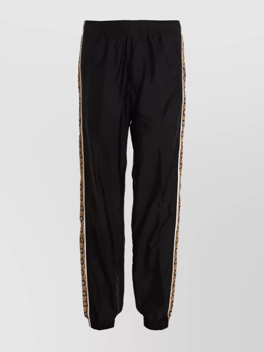 Shop Versace Striped Taffeta Track Pants In Black