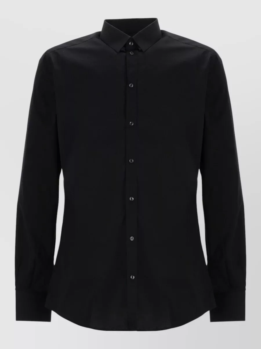 Dolce&Gabbana Stretch cotton shirt — The black regular-fit button-down keeps the all-black line sharp and slightly formal, matching the slim jeans’ tailored streetwear mood for summer evenings without feeling stiff or corporate.