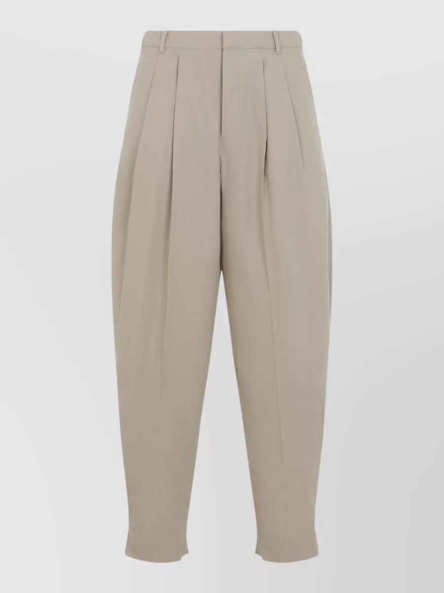 Celine Montauk cotton barrel leg pants — The Celine stone-beige high-rise pleated shorts mirror the shirt’s relaxed tailored mood and warm neutrals, giving a quietly luxurious, structured summer silhouette that lets the Fendi texture stay centre stage.