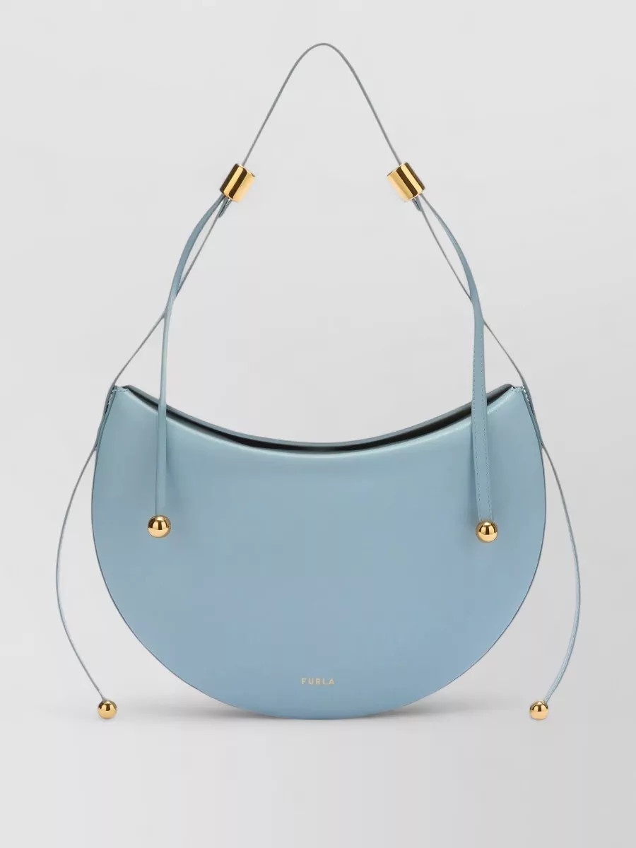 Furla Moonstone m leather shoulder bag — Furla’s powder-blue crescent bag introduces quiet structure and matches the blue story without competing with the stripes, keeping the outfit polished yet relaxed.