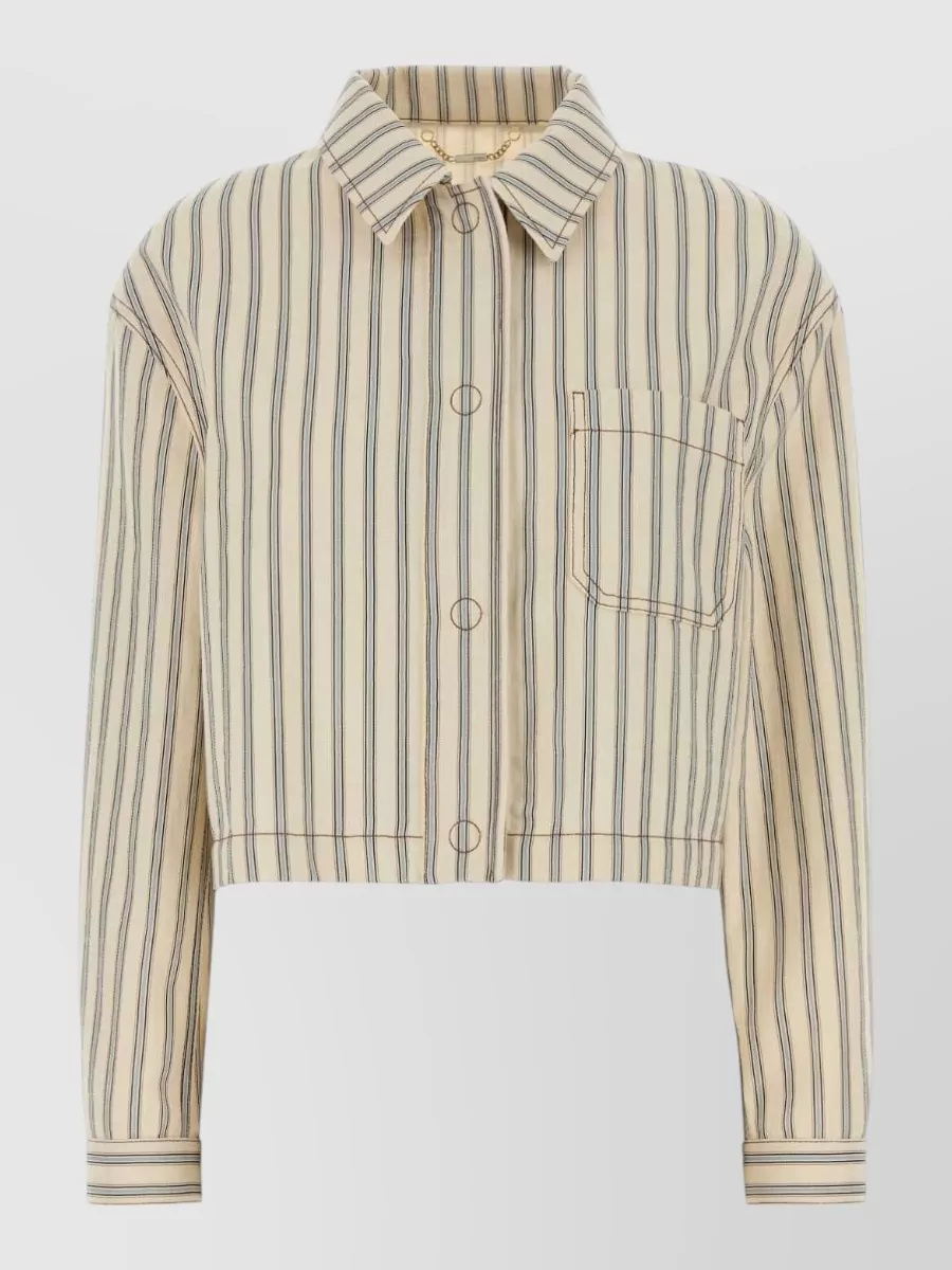 Fendi Denim shirt — The cropped striped Fendi shirt mirrors the Burberry check’s camel and navy tones while keeping things sharp and a bit street, pairing best with high-waisted tailoring and platform sneakers.