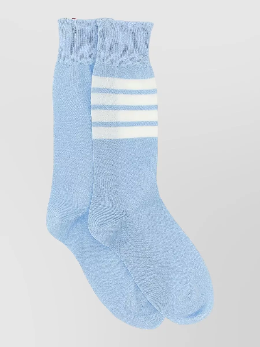 Thom Browne Logo-intarsia socks — The airy ivory and taupe striped wrap introduces subtle texture and a gentle neutral that complements the blues without disrupting the minimalist, sleepwear-inspired mood.