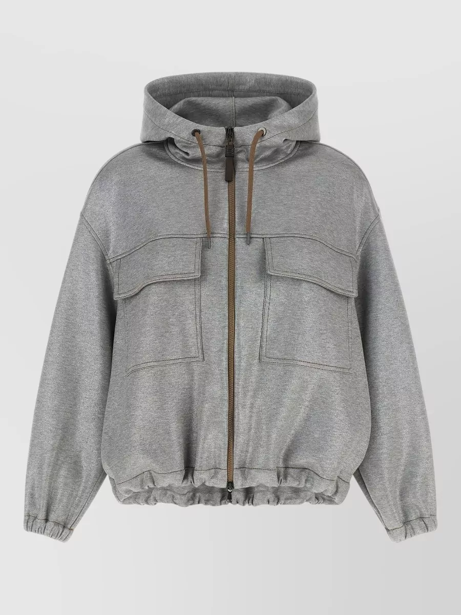 Brunello Cucinelli Cotton bomber hoodie — The Brunello Cucinelli cropped heather-grey hoodie mirrors the Moncler jacket’s quiet luxury and cropped volume, creating a tonal, layered athleisure column at the right formality.