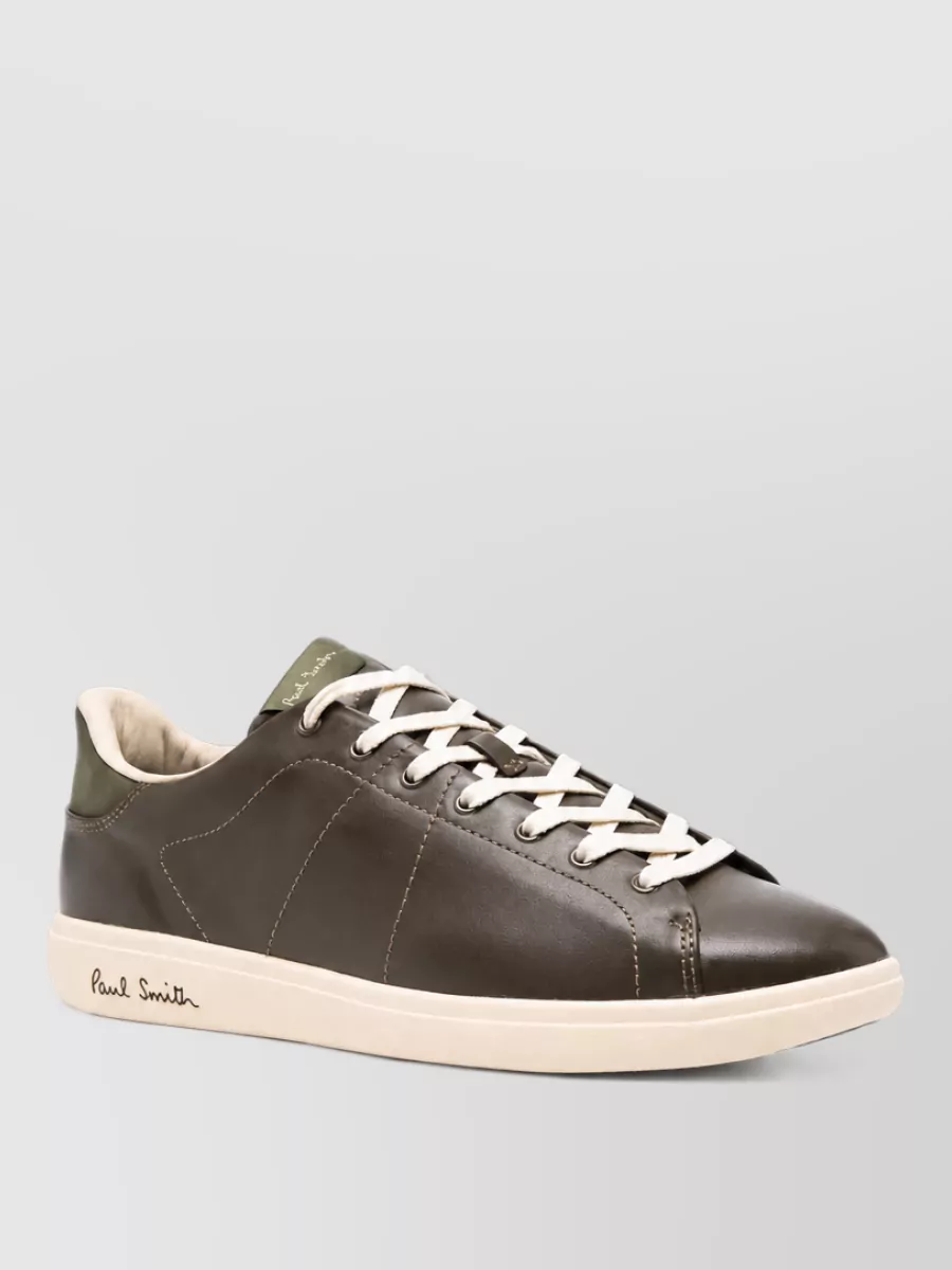 Paul Smith Leather lace-up shoes — The Paul Smith olive-brown leather sneakers echo the sweater and trouser tones and keep the vibe quiet-luxury casual without leaning too far into overtly sporty runner styling.