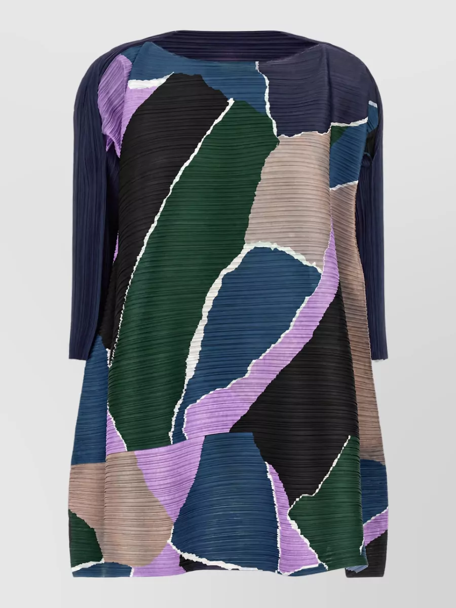 Pleats Please Issey Miyake Pleated blouse — The Pleats Please tunic in B mirrors the skirt’s exact collage and palette for a sculptural co-ord that keeps the boho streetwear mood while elongating the line with its relaxed length.