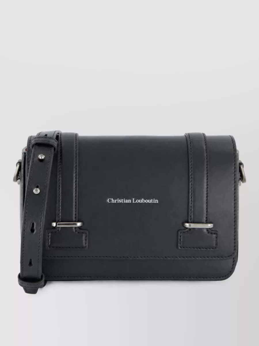 Christian Louboutin Clutch bag — The Christian Louboutin crossbody in G continues the charcoal-black, structured theme and discreet hardware story, giving a compact, urban finish that matches the outfit’s minimalist streetwear polish.