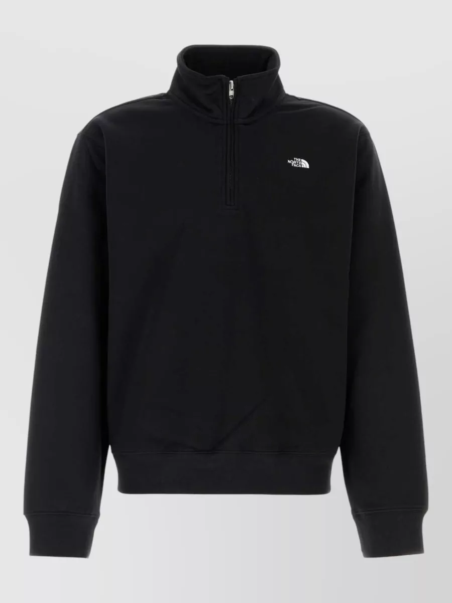 The North Face Cotton blend sweatshirt — The black quarter-zip layers cleanly under the boxy black fleece, keeping the line sharp and technical without bulk while staying within the same The North Face sport-street language.