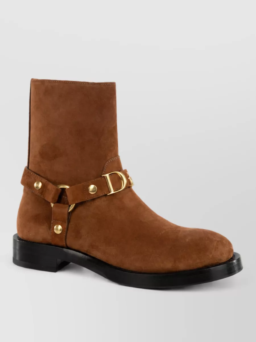 Christian Dior Leather ankle boots — The tan suede ankle boots strike the right balance of polish and ease, their warm cognac tone tying into the shirt’s contrast stitching while grounding the wide-leg denim for smart off-duty wear.