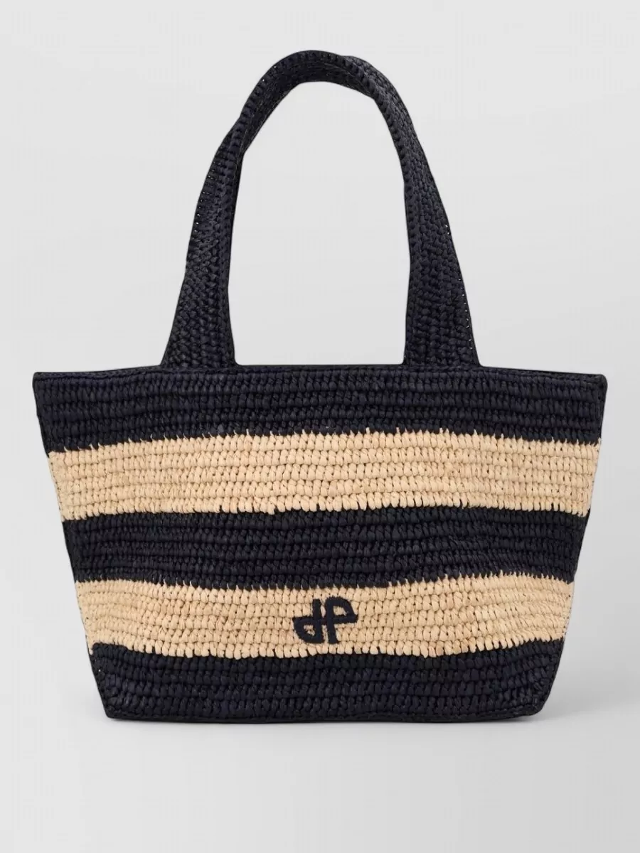 Patou Raffia tote bag — The Patou navy and natural raffia tote leans into collegiate-preppy with a Riviera twist, ties back to the dress’s navy logo, and adds seasonally right texture while staying casual-formal level 3.