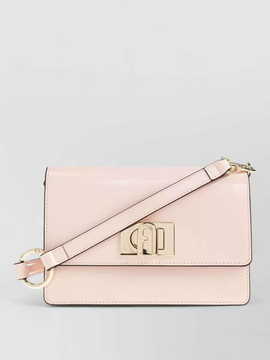Furla 1927 mini leather crossbody bag — The Furla blush cross-body stays within the soft pink family but introduces a subtle warm beige contrast and compact structure, keeping the outfit polished but still understated.