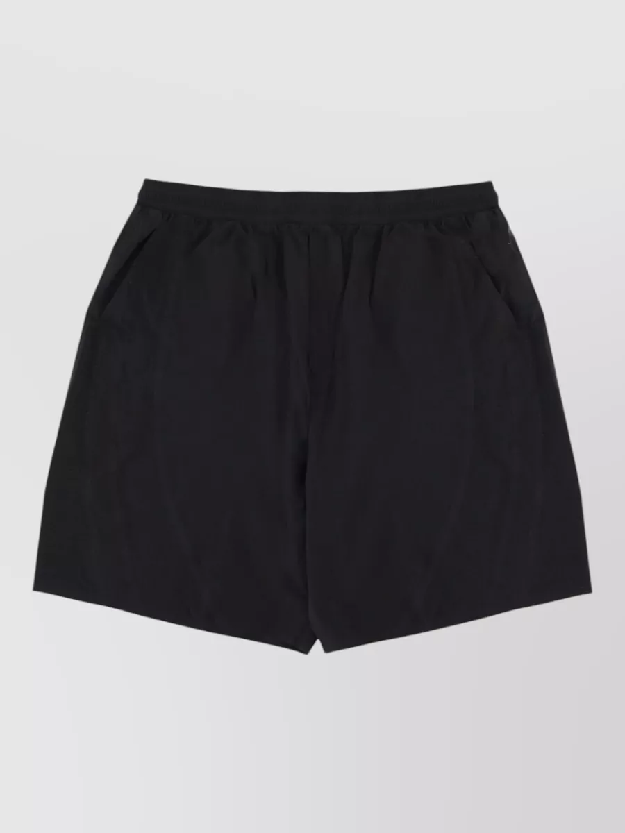 Y-3 Technical straight-leg deck shorts — The clean black Y-3 deck short keeps the mesh tee’s sporty, slightly clubby energy focused while echoing the heart logo and balancing the sheerness with a solid, minimal base.