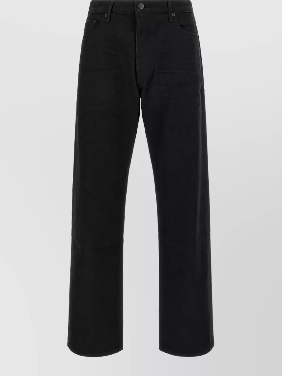 Tom Ford Denim straight-leg jeans — The dark indigo slim denim keeps the outfit relaxed but polished, bridging the olive suede sneakers and charcoal knit with a clean, slightly tailored line.