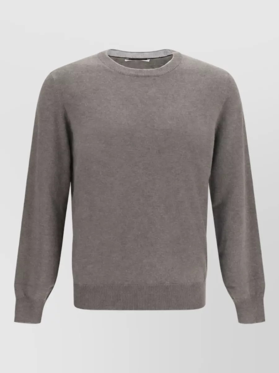 Brunello Cucinelli Cashmere tank top — The heather charcoal long-sleeve knit sits quietly under the shirt-jacket, matching its minimalist mood while softening the all-wool tailoring into an easy, modern city uniform.