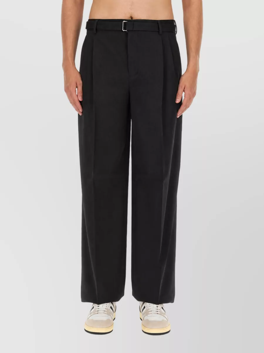 Lanvin Wool wide-leg trousers — The black pleated wide-leg trouser mirrors the sweater’s sculpted texture with an architectural line, keeps the formality quietly polished, and balances the regular crew with a modern, roomy silhouette.