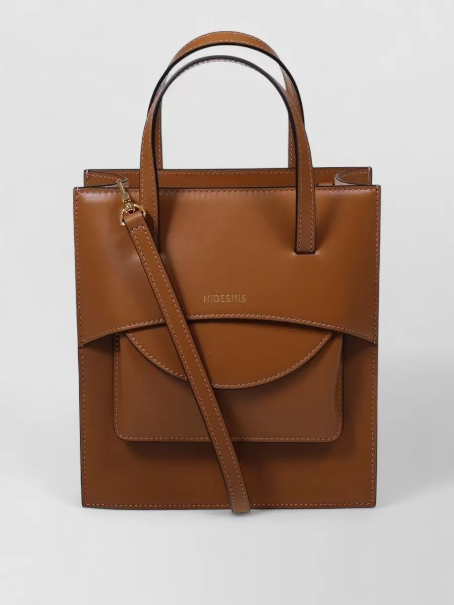 Hidesins Calf leather pocket medium tote bag — Hereu’s sculptural warm-beige tote-shoulder bag keeps to the neutral story and refined tier, its architectural shape complementing the clean lines of the tee and wide-leg jeans.