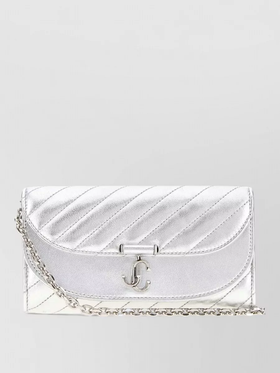 Jimmy Choo Avn leather clutch bag — The metallic silver Jimmy Choo quilted clutch aligns with the shoe’s metal tone and the sequin finish of the dress, creating a coherent, high-glam evening story in the same luxe tier.