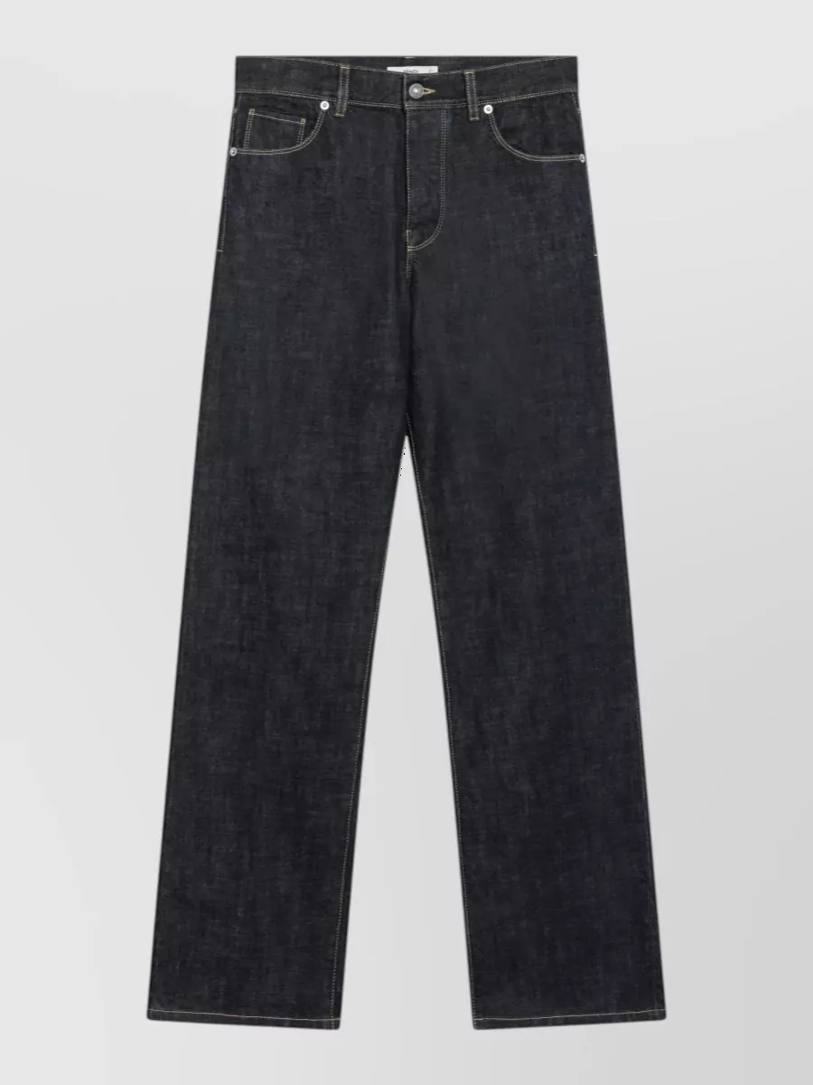 Fendi Denim jeans — The dark wide-leg denim in D mirrors the tee’s minimalist streetwear energy, keeps the palette inky and cohesive, and gives a long clean line that can dress up or down.