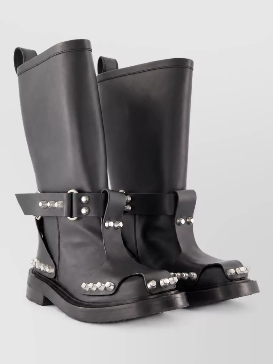Alexander Wang Leather boots — The Alexander Wang knee-high chunky platform boots double down on the mini’s tough attitude and add a heavy, grungy streetwear base that balances the short hem and metallic knit on top.
