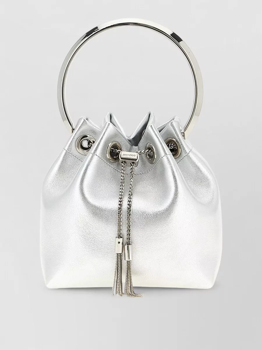 Jimmy Choo bon bon leather bucket bag — The Jimmy Choo metallic silver mini bucket echoes the shoes’ liquid metallic finish and night-out attitude, adding sparkle without breaking the black-and-silver palette.