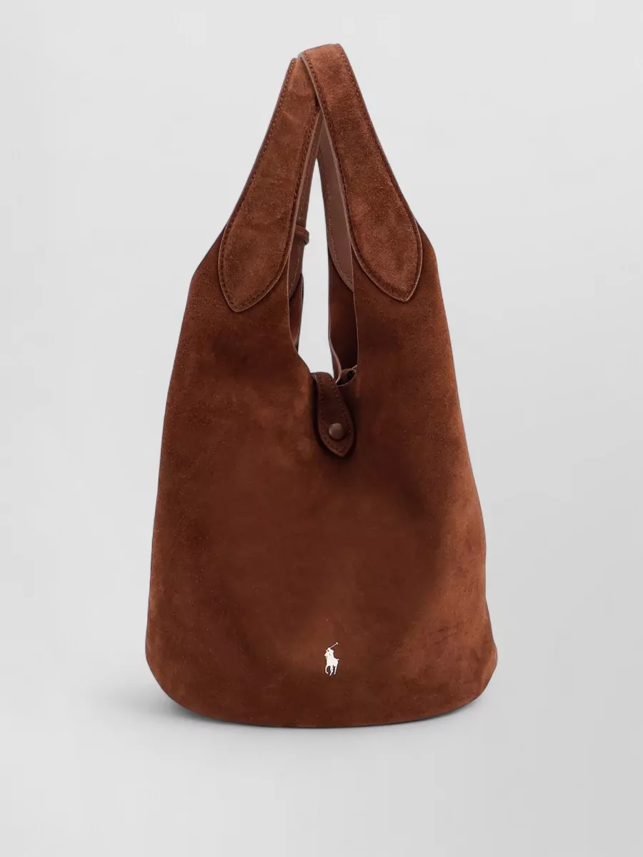 Polo Ralph Lauren Suede bucket bag — The chestnut suede bucket bag adds soft texture and a warm neutral counterpoint to the plum set, staying in the quiet-luxury Polo world without competing with the tonal story.