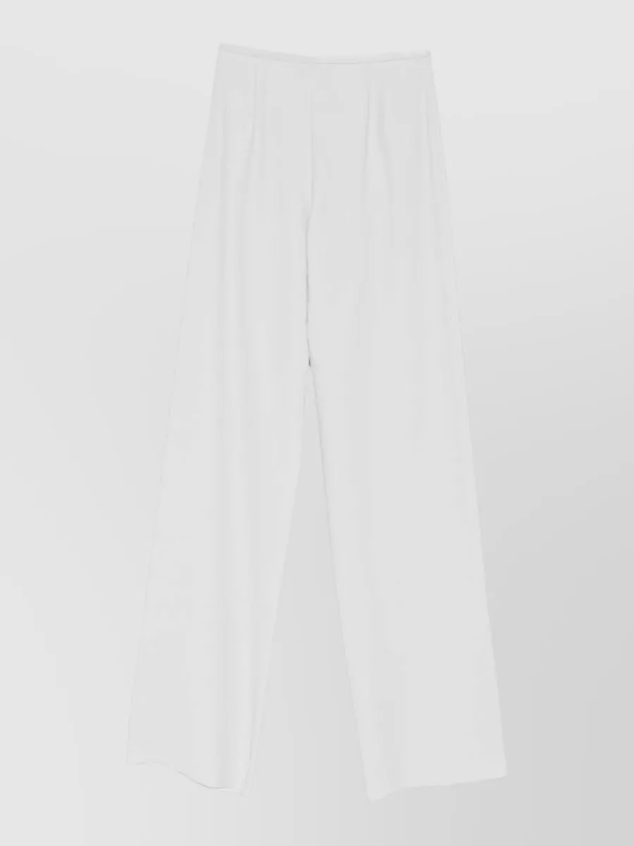 Emporio Armani Wide-leg trousers — The soft white high-waist wide-leg trouser mirrors the jacket’s light palette and tailored minimalism, keeping the formality level while elongating the line under the cropped tweed.
