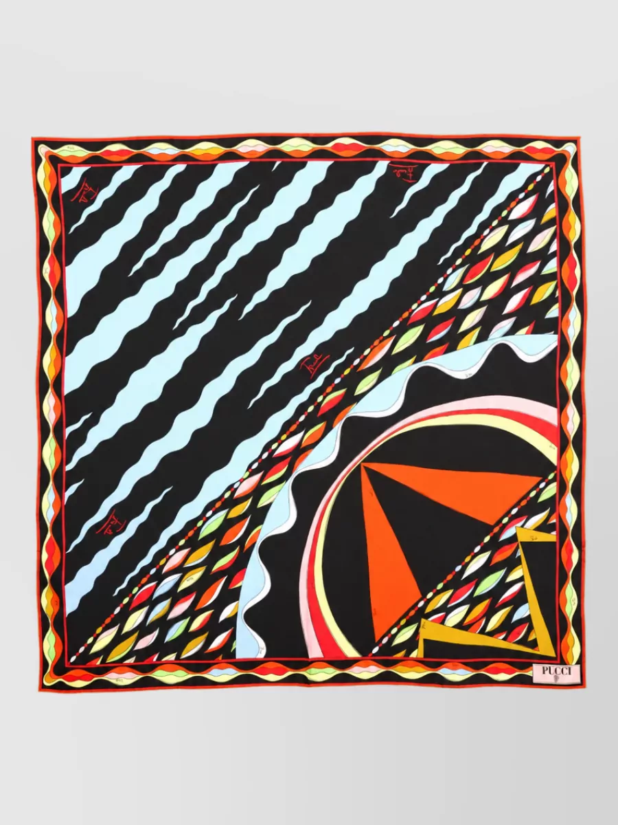 Pucci Silk scarf — The Pucci silk foulard in black with vivid accents can be knotted at the neck or bag, subtly repeating the top’s palette while keeping the rest of the styling clean.