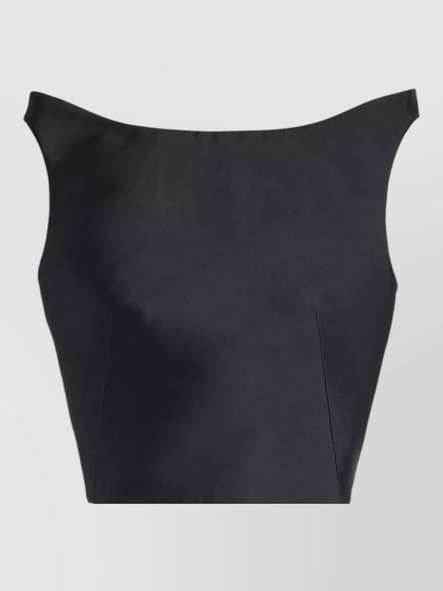 Jil Sander Silk sleeveless cropped top — The Jil Sander off-shoulder black midi mirrors the Fendi baguette’s minimalist, quiet-luxury attitude and silver hardware, creating a clean evening column that keeps the bag’s texture as the subtle statement.