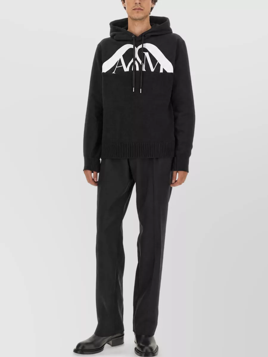 Alexander McQueen Cotton logo tank top — The light grey McQueen hoodie mirrors the short’s tone and branding, giving a cohesive, sport-street set that feels right for cool-season off-duty wear without breaking the minimalist mood.