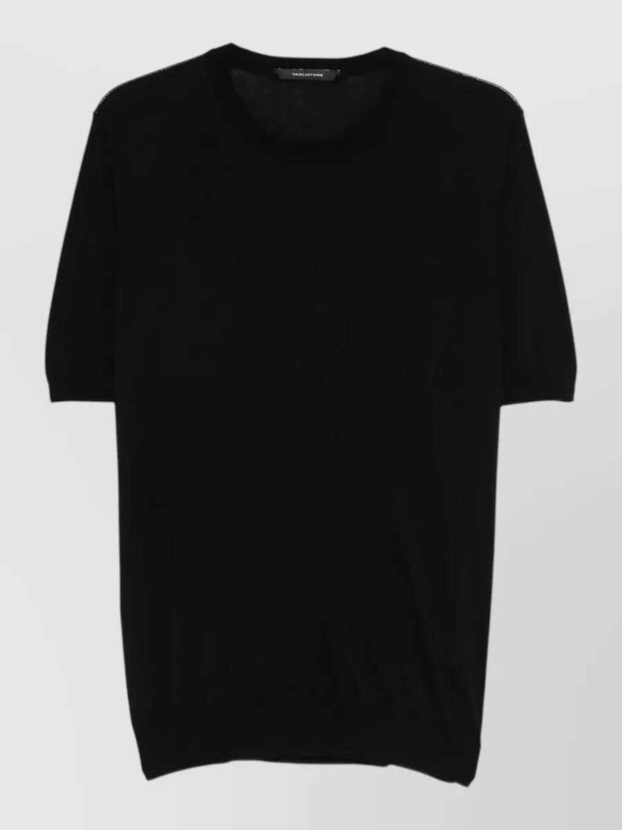 Tagliatore Short-sleeve cotton sweater — The black pleated Homme Plissé tee matches the gilet’s fabric, texture and cut, creating a seamless monochrome column that feels intentional and architectural.