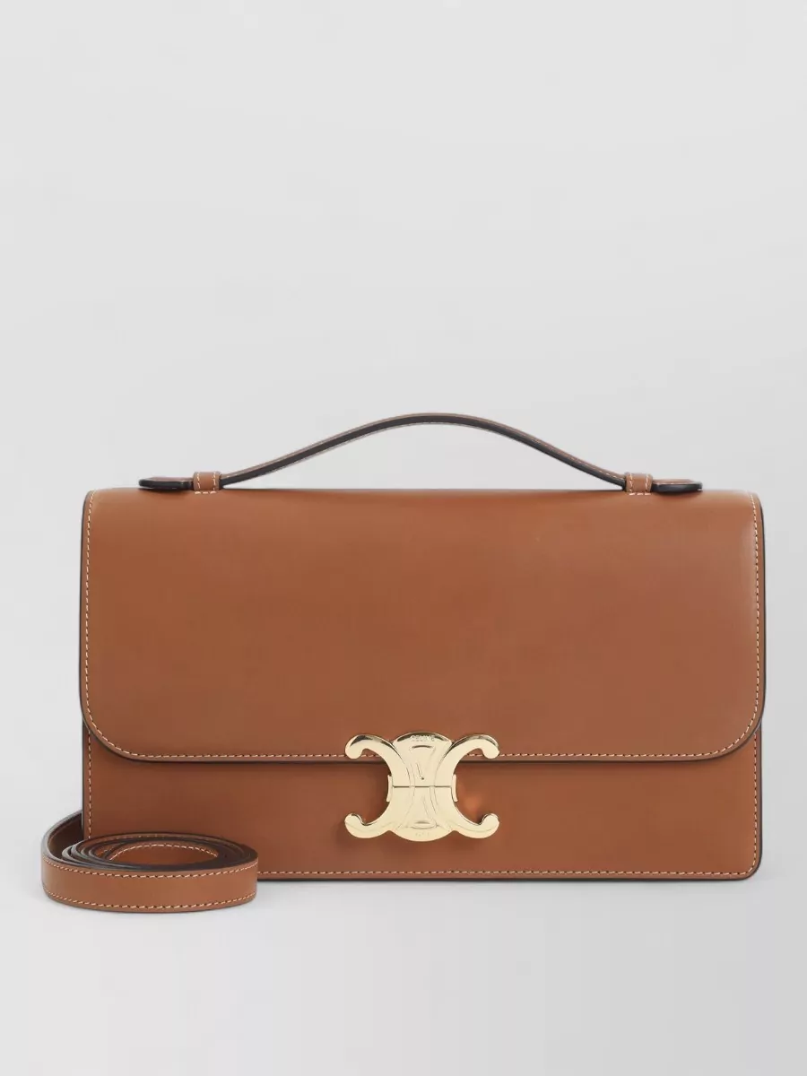 Celine Leather cross-body bag — The structured navy Celine top-handle bag ties into the jacket’s dusty blue palette while reinforcing the tailored, French-preppy attitude and formal level of the outfit.