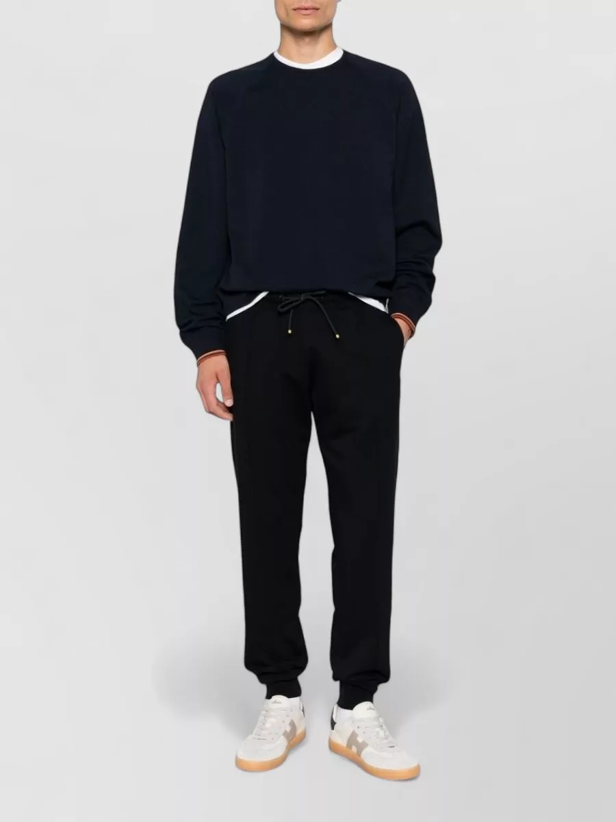 Paul Smith Cotton blend track pants — The Paul Smith black tapered track pant mirrors the tee’s minimalist sport energy, keeps the palette tight, and sits in the same refined-casual tier with an easy, regular silhouette.