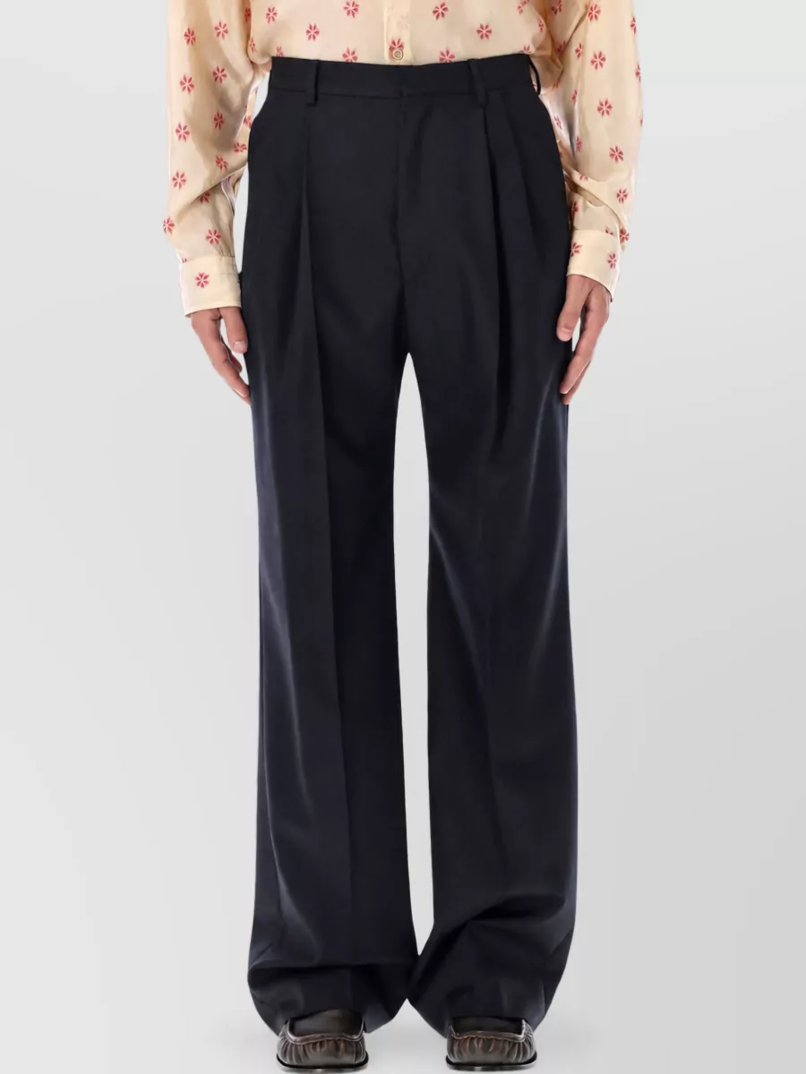Dries Van Noten Herringbone high-rise straight-leg wool tailored trousers — The high-waisted deep navy wide-leg trouser keeps the outfit quietly luxe and architectural, complementing the tee’s baroque texture without adding more print while the volume balances the boxy top.