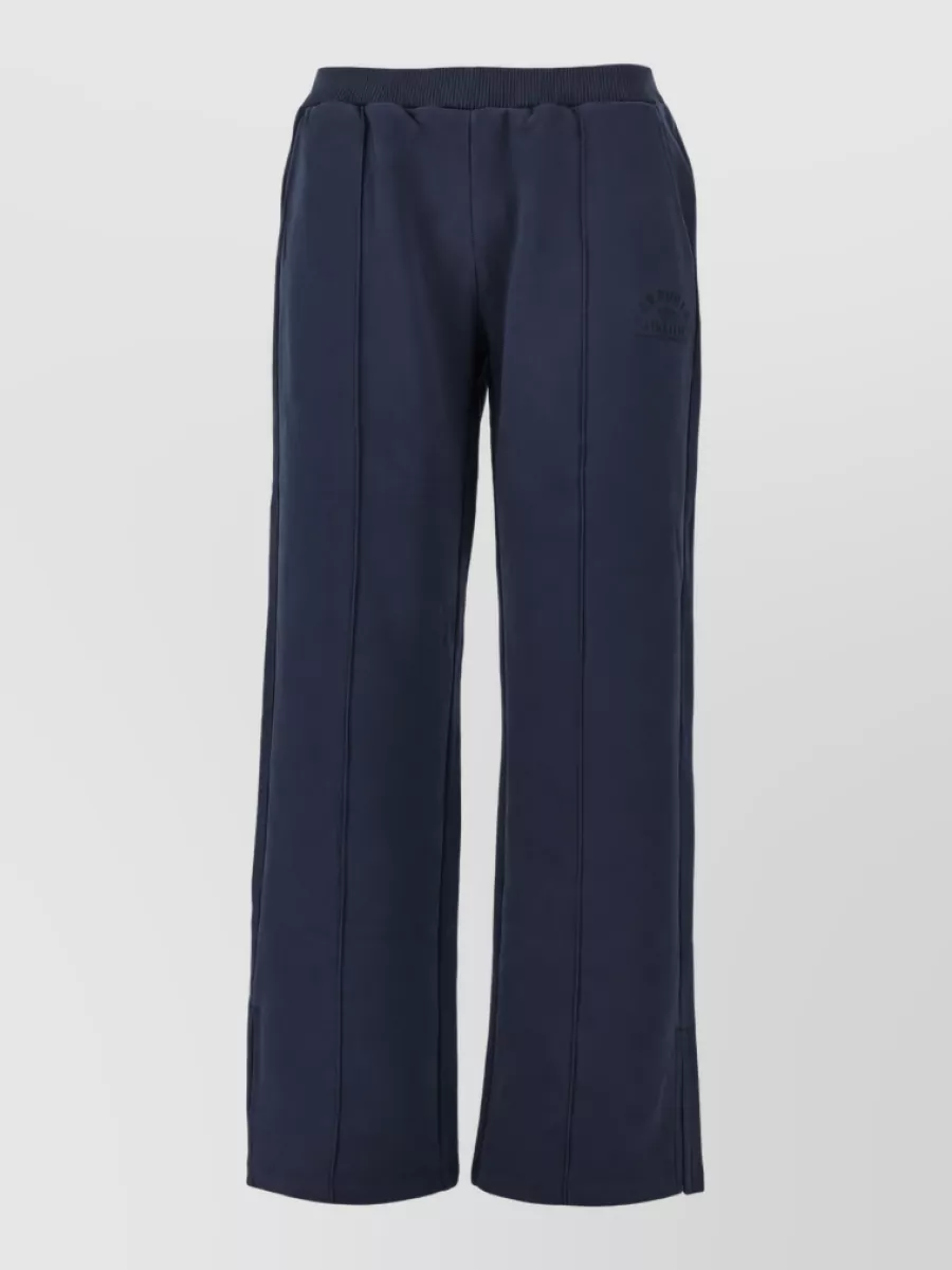Emporio Armani Loungewear top — The navy straight-leg Emporio Armani lounge jogger mirrors the hoodie’s sporty-minimal mood and color story, creating a quiet matching set that stays relaxed yet polished for travel and off-duty.