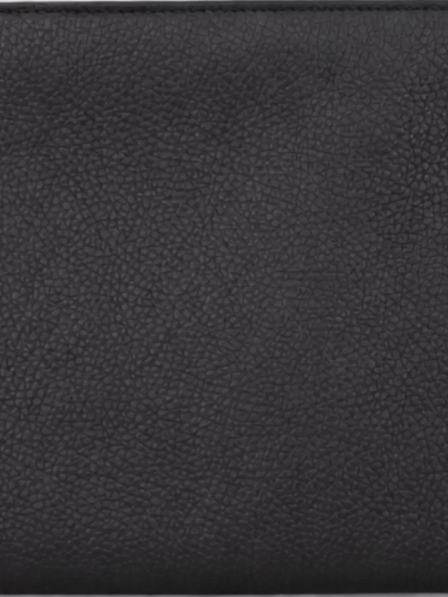 Gucci Leather clutch bag — The Ferragamo brief-style bag in black and charcoal adds structured, business-leaning refinement and a darker anchor that complements the minimalist, tailored mood without fighting the neutrals.
