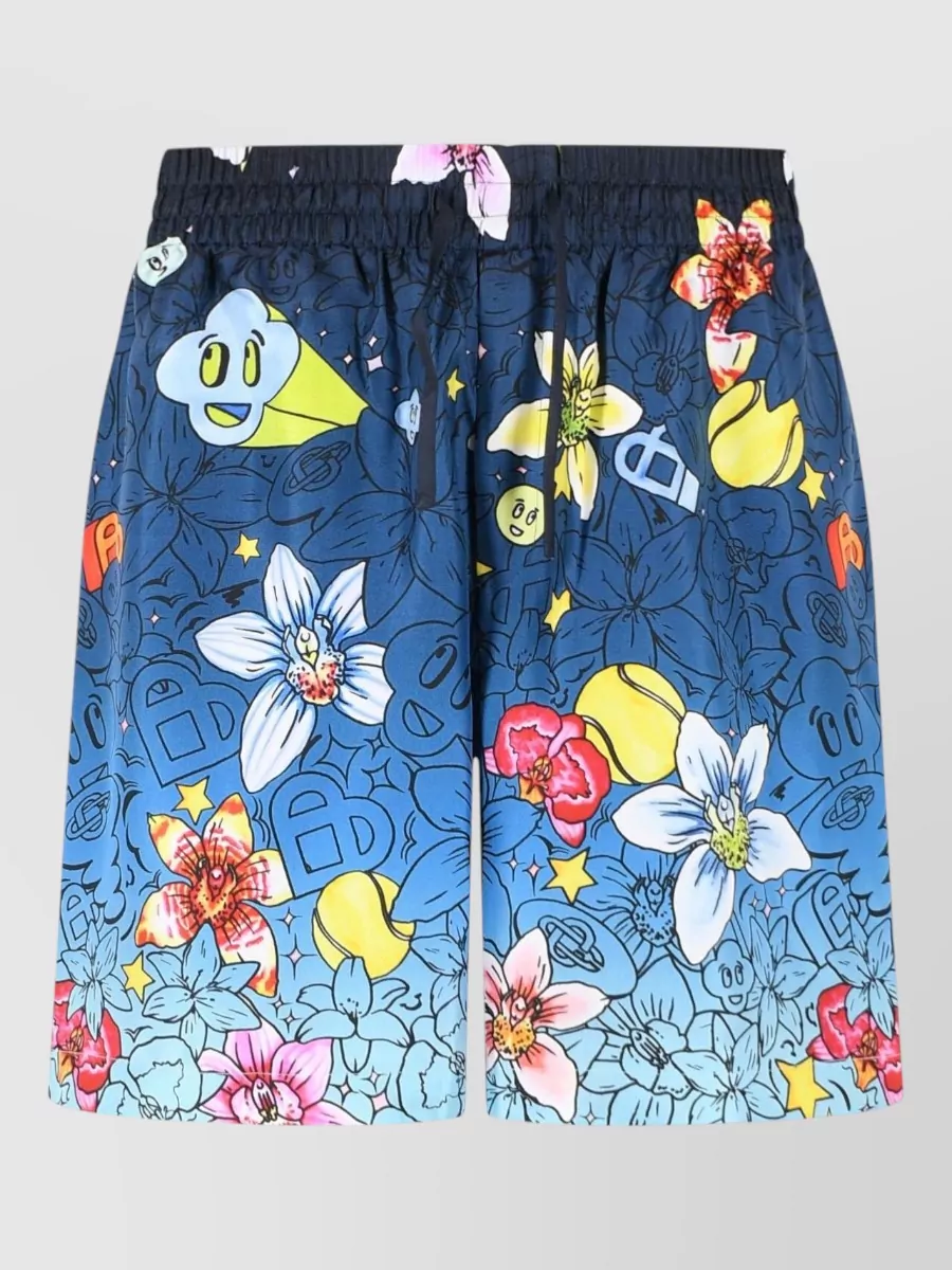 Casablanca Silk deck shorts — The navy–sky–yellow cartoon floral shorts mirror the shirt’s exact palette and playful graphic language, creating a cohesive, high-energy set without competing prints.