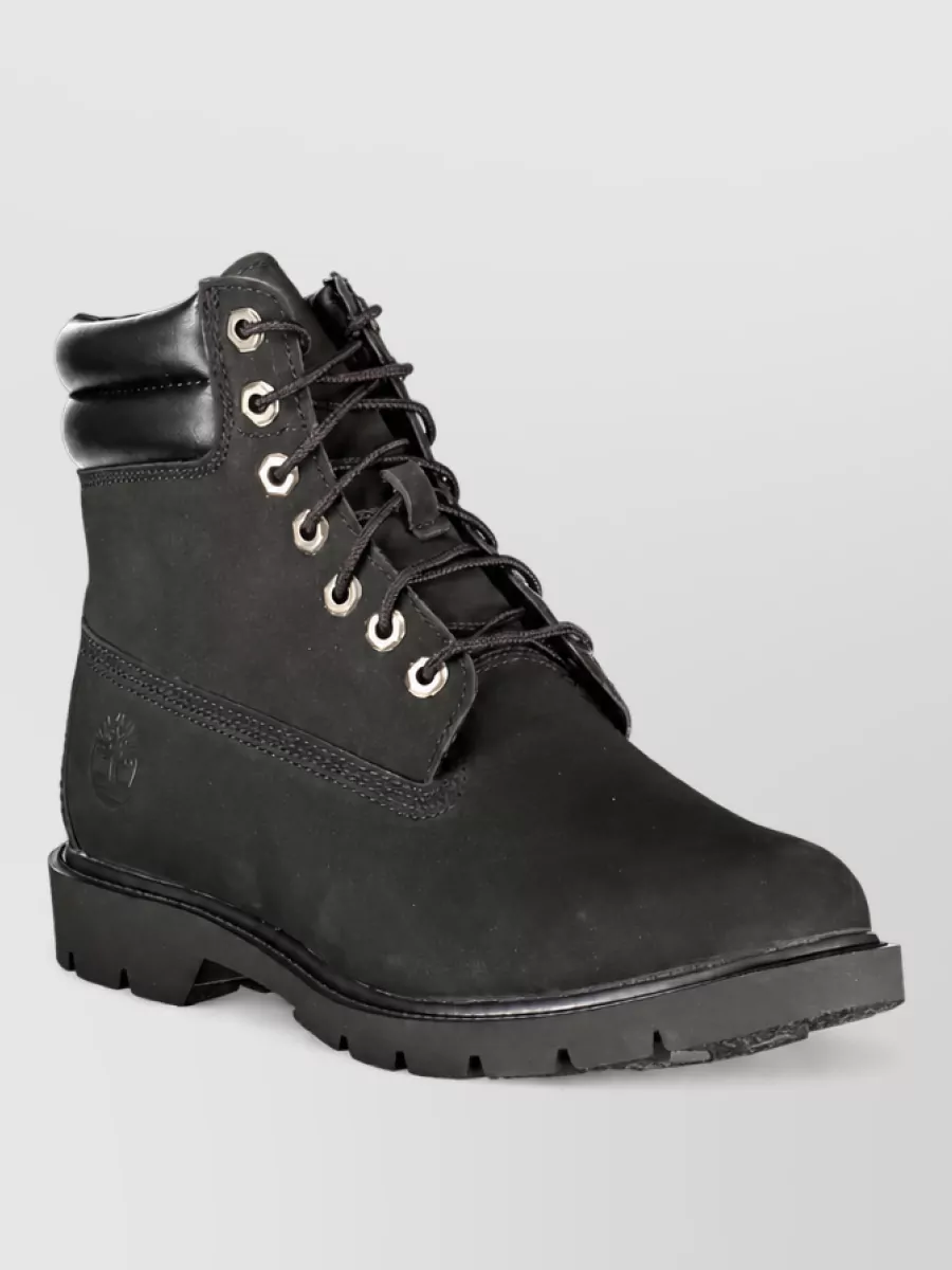 Timberland Leather ankle boots — The matte black Timberland boots sharpen the palette, sit perfectly with washed charcoal trousers and keep the workwear energy strong without adding more warm tones.