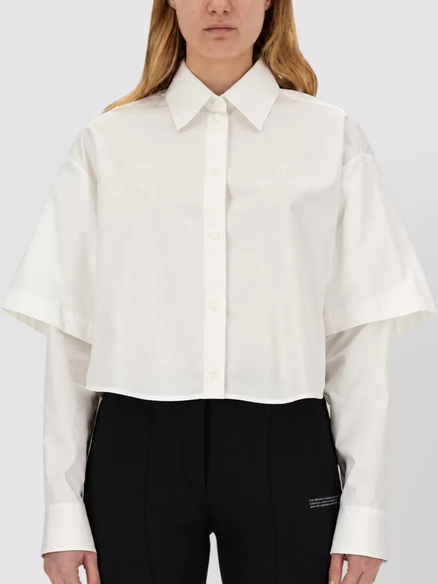 Off-White Poplin shirt — The cropped, boxy white shirt keeps the waistline visible, sharpens the high-rise wide leg, and matches the minimalist Off-White tailoring story in a clean black-and-white palette.