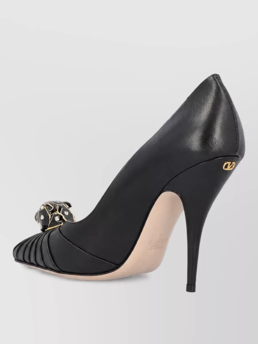 Valentino Garavani Leather high-heel pumps — The jeweled-bow pointed pumps mirror the crystal detail on the top, elongate the leg under the high-low hem and match the romantic, cocktail-ready formality of the skirt.