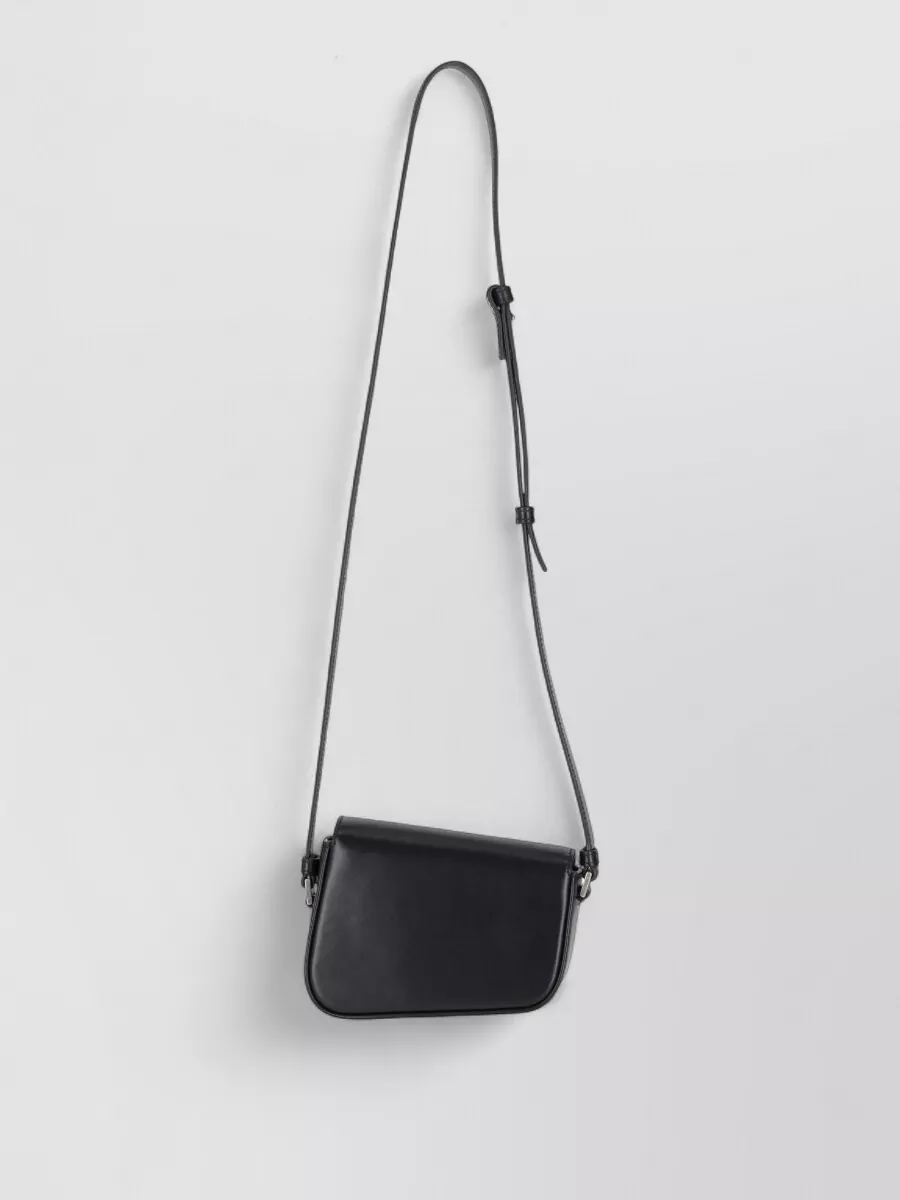 Palm Angels crash leather cross-body bag — The slim black Palm Angels crossbody stays in the same brand universe, adds just enough structure, and keeps the whole set minimal and hands-free for travel and city movement.