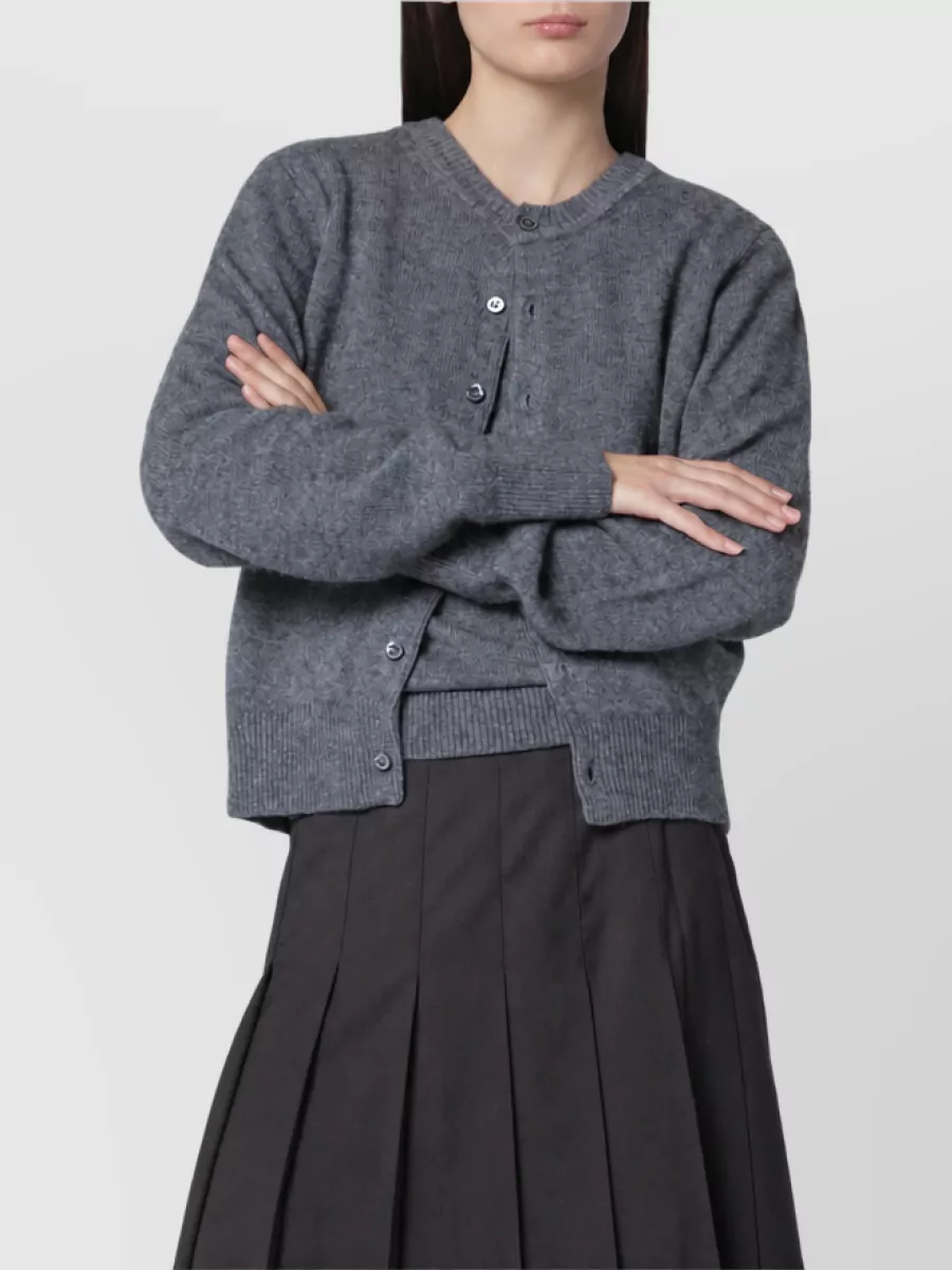 Dunst Cardigan — The charcoal cardigan neatly echoes the skirt’s check in both tone and mood, giving a clean, collegiate knit layer that can be buttoned or worn open without competing with the mini.