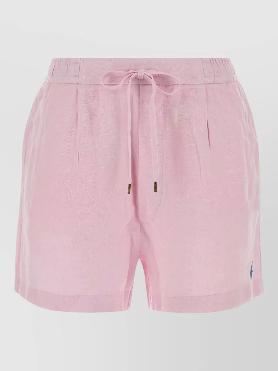 Polo Ralph Lauren Linen pleated mid-rise bermuda shorts — The crisp white pull-on shorts keep the preppy, romantic palette light and polished, giving a chic contrast to the pastel pink cable knit while matching its slightly more refined formality.