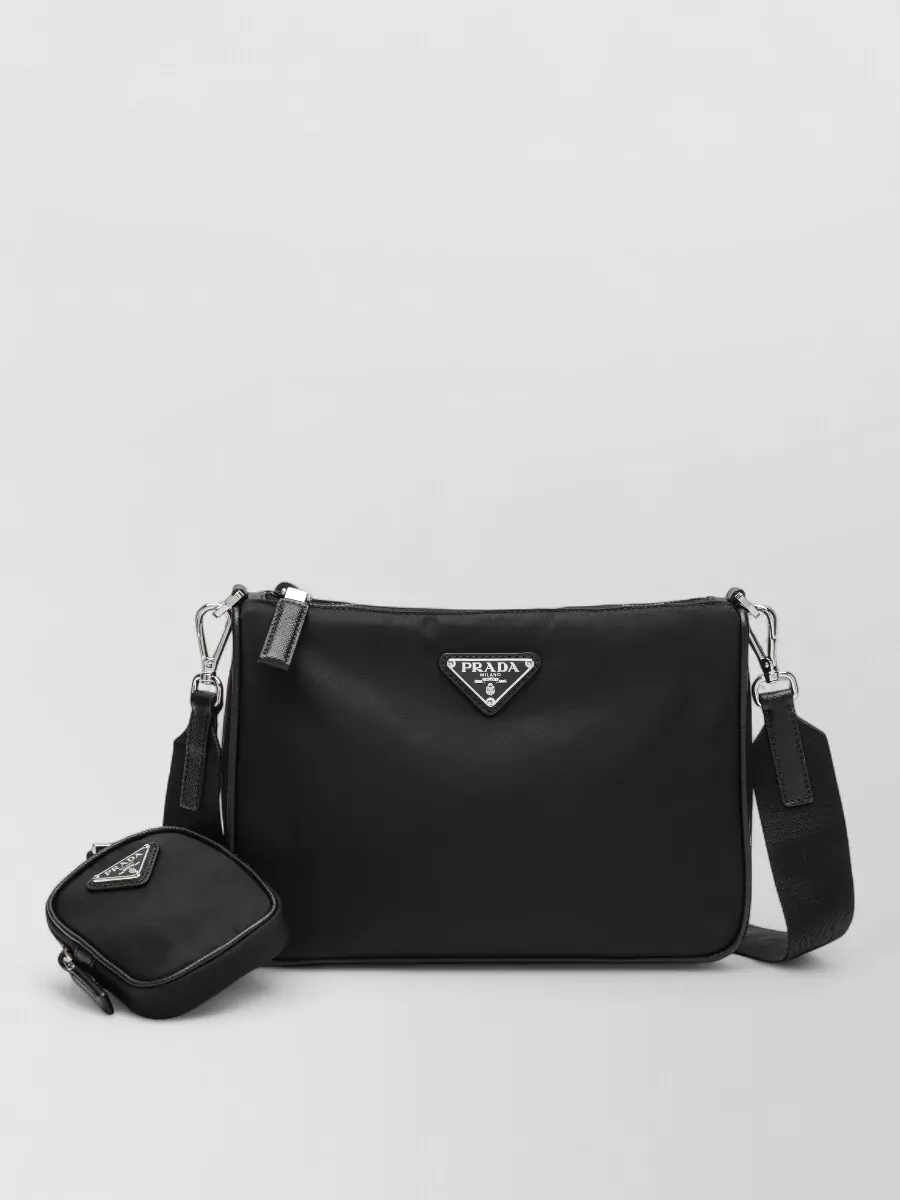 Prada Leather shoulder bag — The black Prada crossbody brings quiet-luxury hardware and a clean rectangular shape, aligning with the elevated street vibe of Palm Angels while staying practical and compact.