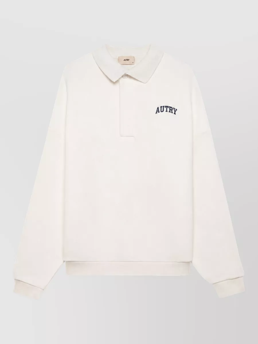 Autry Cotton polo shirt — The off-white long-sleeve polo keeps the palette light and collegiate against the royal blue track pant, echoing the sport-preppy mood without competing for color.