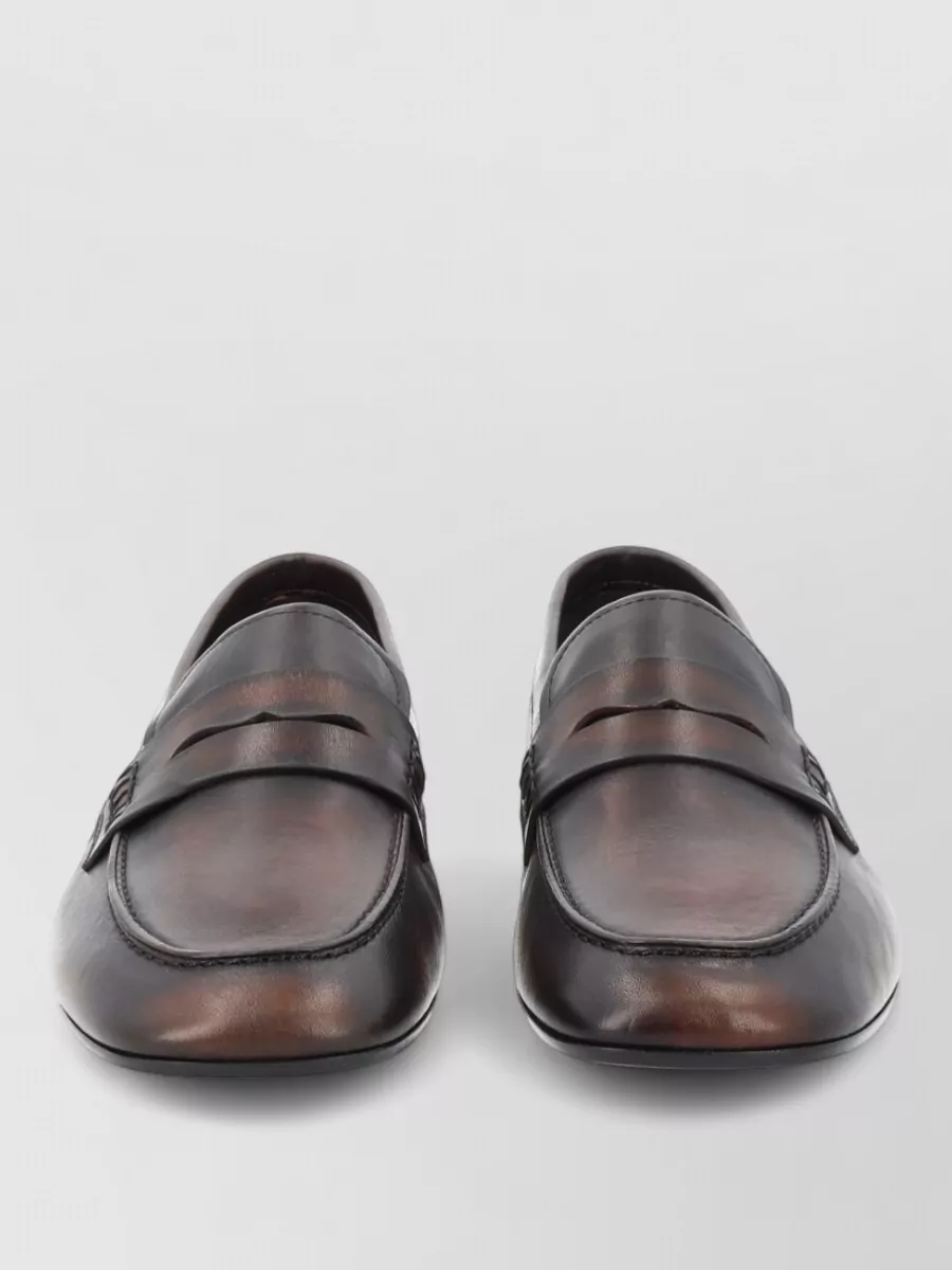 Dries Van Noten Leather loafers — C’s burnished espresso loafer keeps the mood tailored and quietly luxurious, grounding the wide-leg suit with a low, formal heel that works from client meeting to dinner.