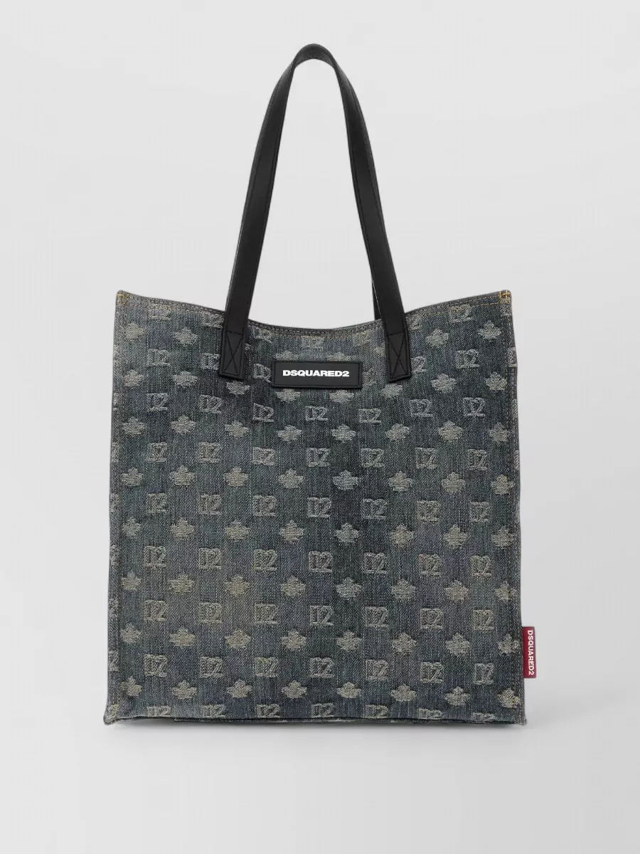 Dsquared2 Embroidered denim tote bag — The washed charcoal monogram tote reinforces the denim story and urban attitude, its darker tone tying neatly into the washed black jeans while staying casual and brand-consistent.