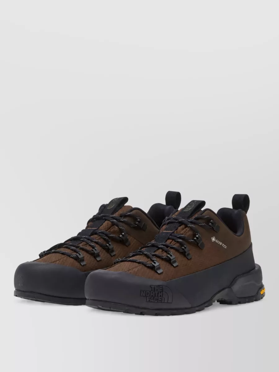 The North Face Gore-tex low hiking boots — The dark brown and black trail shoe echoes the jacket’s color-blocking and adds rugged practicality that works in the city and outdoors.