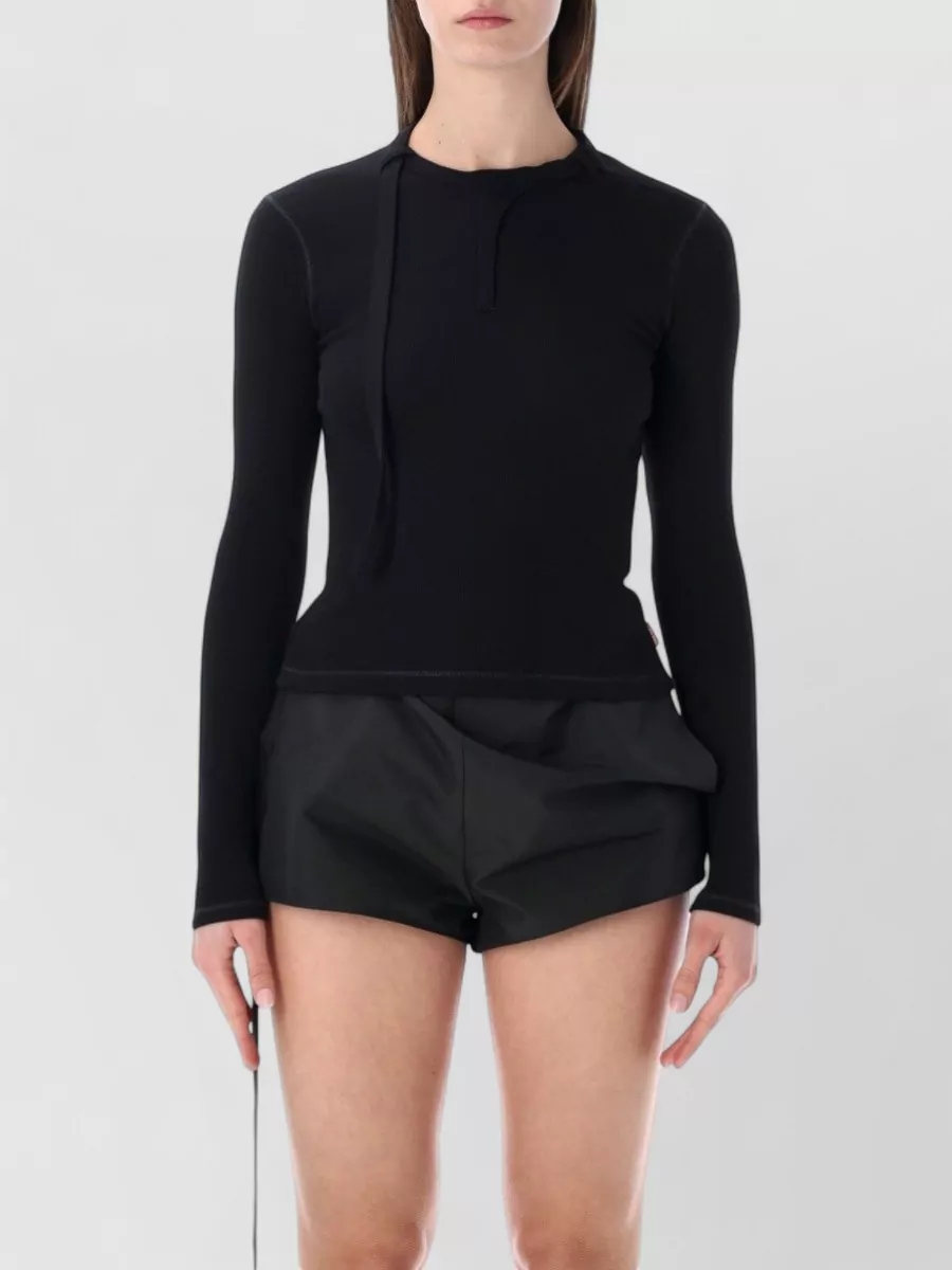 Diesel Ribbed slim-fit long-sleeve cutout top — The slim black Diesel ribbed long-sleeve keeps the silhouette clean and body-conscious against the relaxed Rick-style shorts, staying true to a minimalist monochrome street-sport mood.